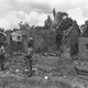 Nigerian federal troops wait to move their position, surrounded by gutted buildings at Ngu, about 10 miles from Umuahia, 1969.